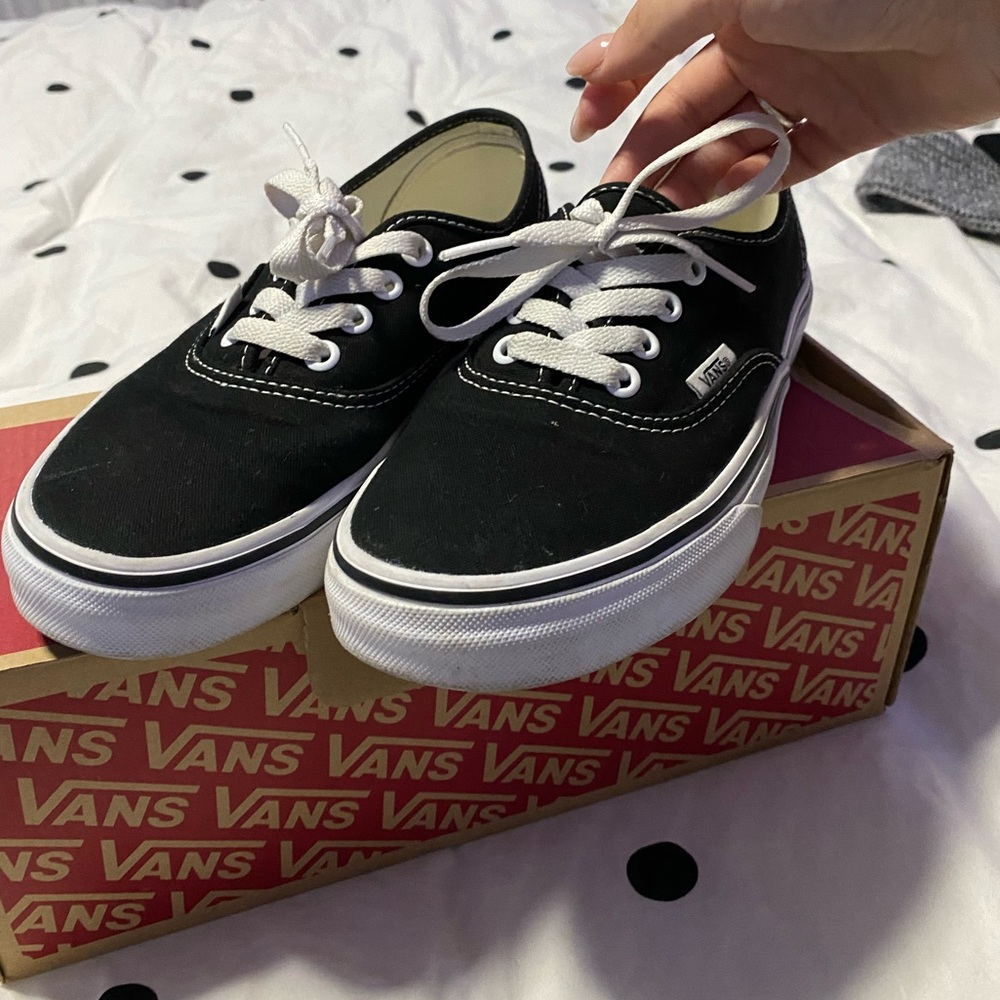 Black and white low top vans